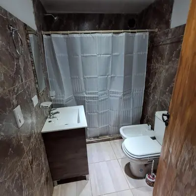 a bathroom with a sink and a toilet and a shower at Cabaña EL AROMO in La Paz