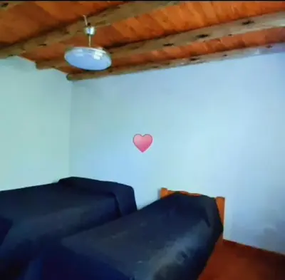 a room with two blue couches and a heart on the wall at Cabaña EL AROMO in La Paz