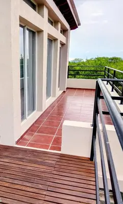 a balcony with a view of a house at Casa de la Sierras in Cerro de Oro