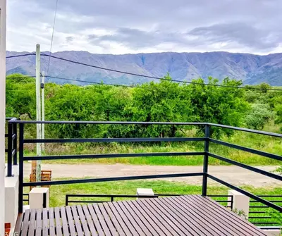 a balcony with a table and a view of mountains at Casa de la Sierras in Cerro de Oro
