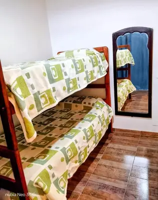 a bedroom with a bunk bed and a mirror at Casa de la Sierras in Cerro de Oro