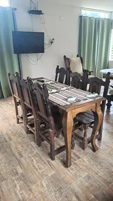 a dining room table with chairs around it at Casa de la Sierras in Cerro de Oro
