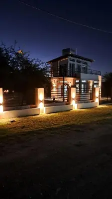 a house with lights in front of it at night at Casa de la Sierras in Cerro de Oro