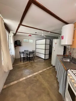 a kitchen and dining room with a table in it at Complejo Villa Lago in Villa Carlos Paz