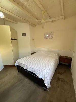 a bedroom with a white bed in a room at Complejo Villa Lago in Villa Carlos Paz