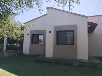 a white house with a car parked in front of it at Berna in Carpintería