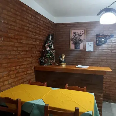 a dining room with a table and a christmas tree at Hostería Huanel in Villa Cura Brochero