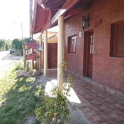 a brick building with a sign on the side of it at Hostería Huanel in Villa Cura Brochero