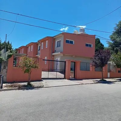 a red building on the side of a street at Apartment Playas de Oro Villa Carlos Paz in Villa Carlos Paz