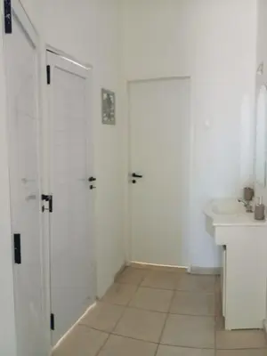 a white bathroom with a toilet and a sink at Apartment Playas de Oro Villa Carlos Paz in Villa Carlos Paz