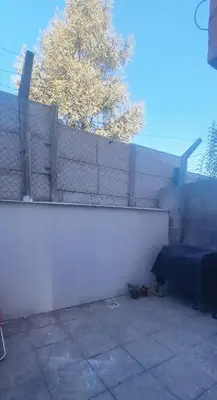 a white fence in front of a white wall at Apartment Playas de Oro Villa Carlos Paz in Villa Carlos Paz