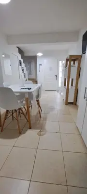 a room with a table and chairs on a tiled floor at Apartment Playas de Oro Villa Carlos Paz in Villa Carlos Paz