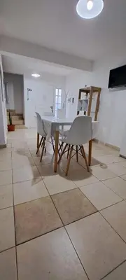 a dining room with a table and chairs on a tile floor at Apartment Playas de Oro Villa Carlos Paz in Villa Carlos Paz