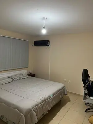 a bedroom with a bed and a air conditioner at Confortable departamento en el centro de la ciudad in Cordoba