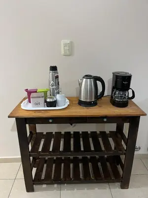 a table with a coffee maker and a coffee pot on it at Confortable departamento en el centro de la ciudad in Cordoba