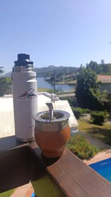 a cup sitting on a table next to a drink at Casa Mirta in Villa Carlos Paz