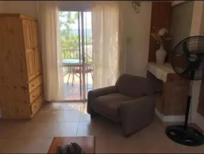a living room with a couch and a sliding glass door at Vito in Villa Carlos Paz