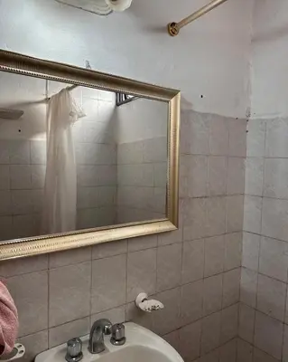 a bathroom with a sink and a mirror at Viva raíz in Nono