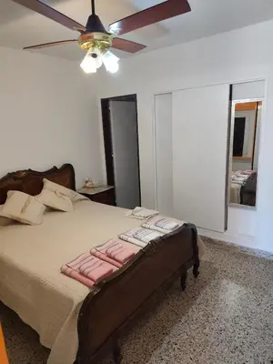 a bedroom with a bed with a ceiling fan at Complejo MIAMI BEACH in Villa Carlos Paz
