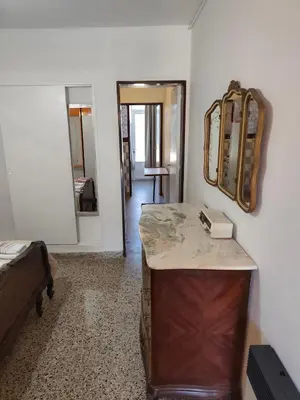 a room with a vanity with a mirror and a sink at Complejo MIAMI BEACH in Villa Carlos Paz