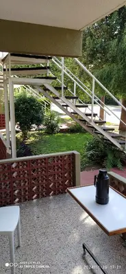 a tea kettle sitting on a table on a patio at Complejo MIAMI BEACH in Villa Carlos Paz