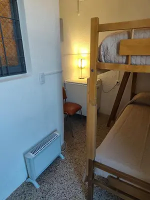 a small room with a bunk bed and a desk at Complejo MIAMI BEACH in Villa Carlos Paz