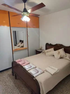 a bedroom with a bed with a ceiling fan at Complejo MIAMI BEACH in Villa Carlos Paz