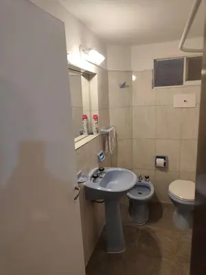 a bathroom with a sink and a toilet at Complejo MIAMI BEACH in Villa Carlos Paz