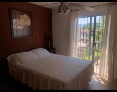 a bedroom with a white bed and a window at Vito in Villa Carlos Paz
