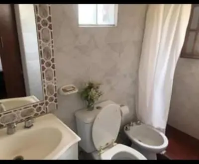 a bathroom with a toilet and a sink at Vito in Villa Carlos Paz