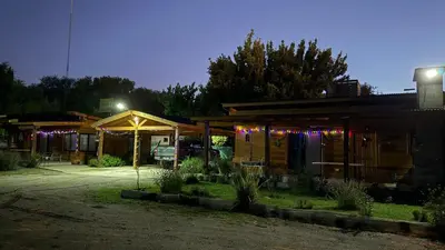 a group of buildings with lights on them at night at Complejo de cabañas Munay Ki in Santa Rosa de Calamuchita