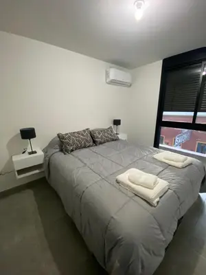 a bedroom with a large bed with two towels on it at Hale Kalena in Cordoba