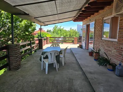 a patio with a table and chairs on it at Balcones del sol in Mina Clavero