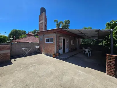 a patio with a brick building with a roof at Balcones del sol in Mina Clavero