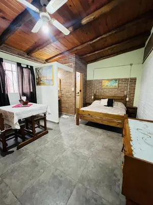 a large room with a bed and a table at Monoambiente in Santa Rosa de Calamuchita