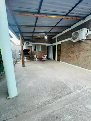 a large patio with a brick wall and a fan at Monoambiente in Santa Rosa de Calamuchita