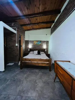 a bedroom with a large bed in a room at Monoambiente in Santa Rosa de Calamuchita