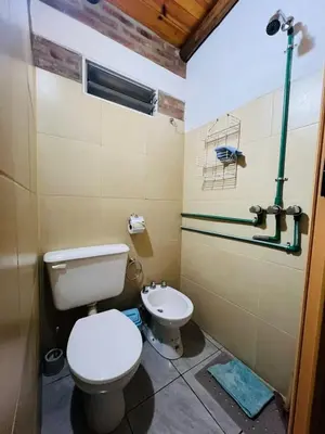 a bathroom with a toilet and a sink at Monoambiente in Santa Rosa de Calamuchita