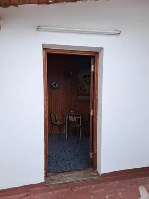 a door leading into a room with a table at Departamentos Córdoba in Mina Clavero