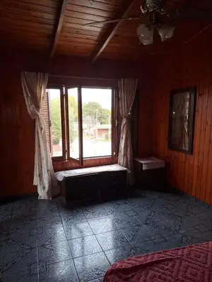 a room with a large window in a bedroom at Departamentos Córdoba in Mina Clavero