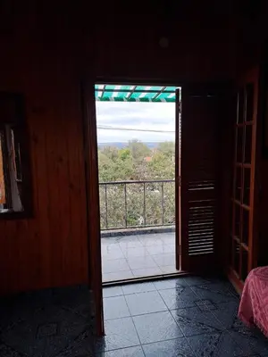 an open door to a balcony with a view at Departamentos Córdoba in Mina Clavero
