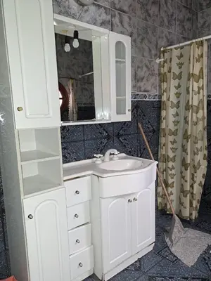 a bathroom with a white sink and a mirror at Departamentos Córdoba in Mina Clavero