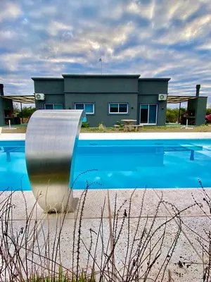 a house with a swimming pool and a building at Tierra de Zorros in Cortaderas