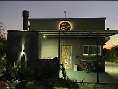 a house with a bike parked in front of it at Tierra de Zorros in Cortaderas