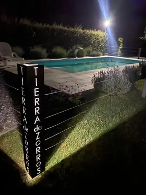 a swimming pool in a yard at night at Tierra de Zorros in Cortaderas