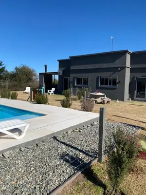 a house with a swimming pool in front of it at Tierra de Zorros in Cortaderas