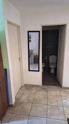 a bathroom with a toilet and a mirror at GEO departamento in Cordoba