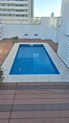 a large blue swimming pool on top of a building at GEO departamento in Cordoba