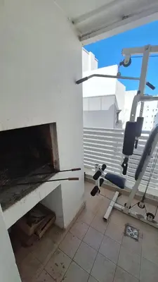a room with a fireplace with a chair in it at GEO departamento in Cordoba