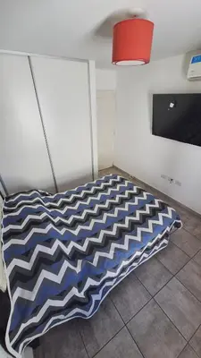 a bed in a room with blue and white at GEO departamento in Cordoba